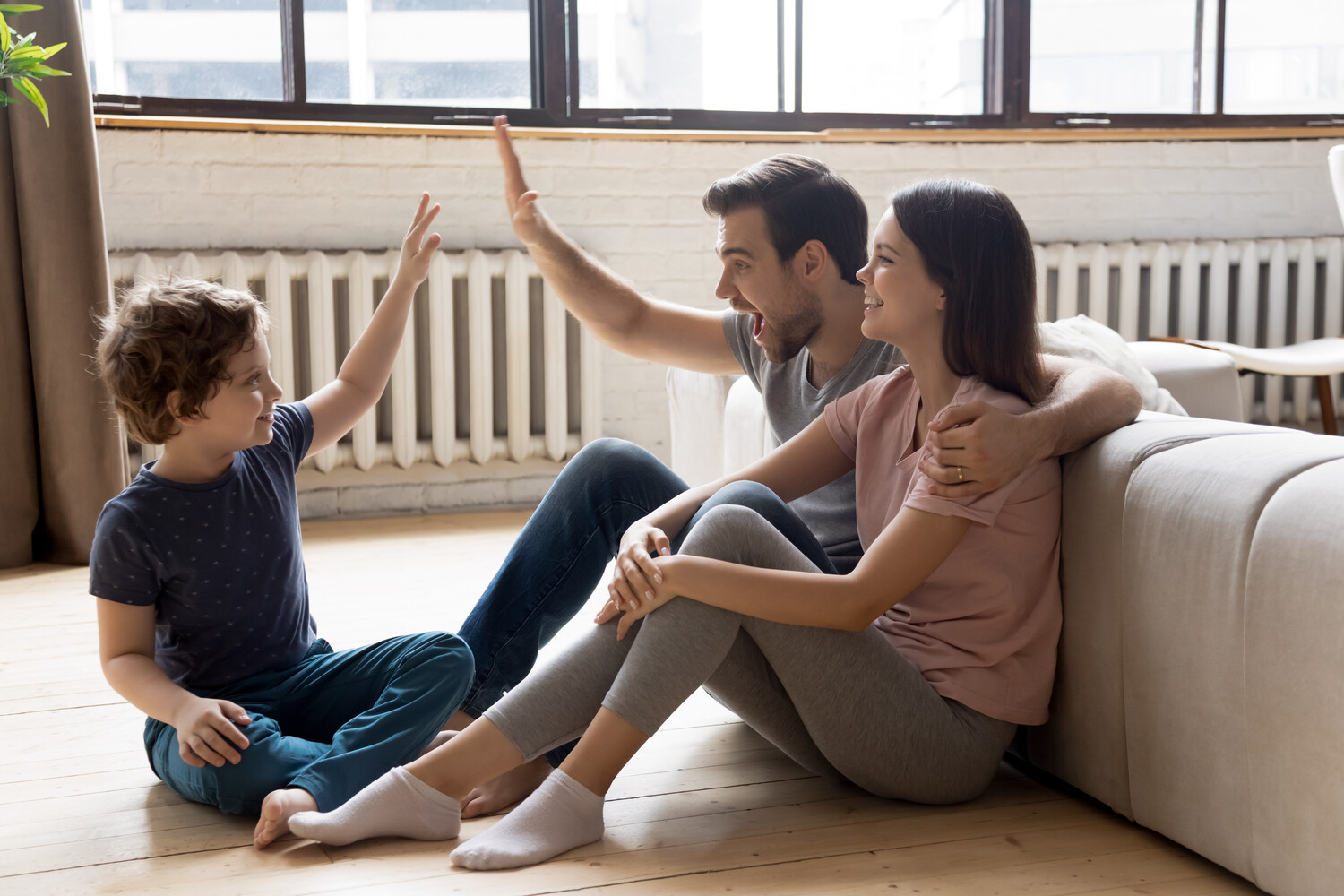 Familie im Wohnzimmer vor der Heizung